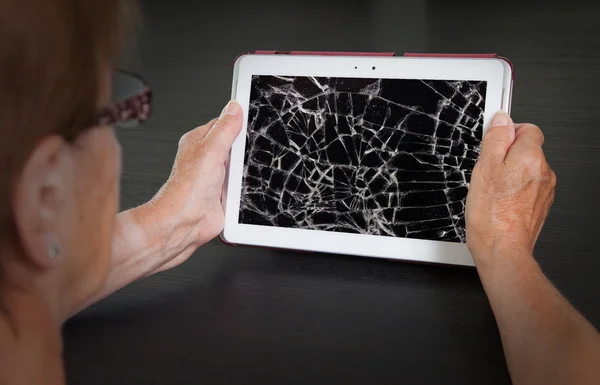 Senior lady with tablet, cracked screen