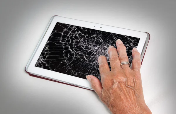 Senior lady with tablet, cracked screen