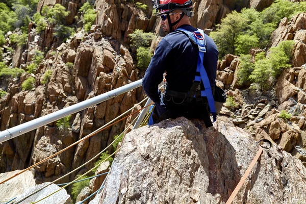 Rescue Workers practicing a Rescue Drill on Ledge of Mountain