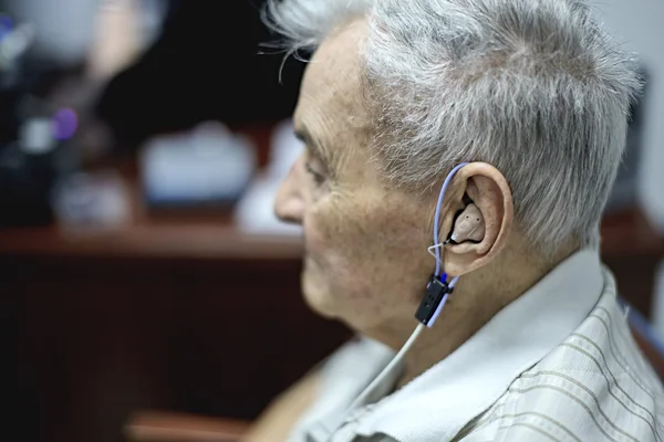 Elderly Man gettng a Hearing Test