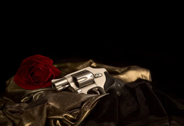 Revolver on Satin with Red Rose
