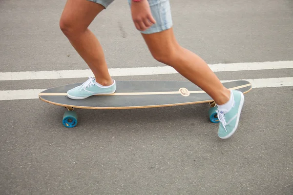 Girl skating on a longboard