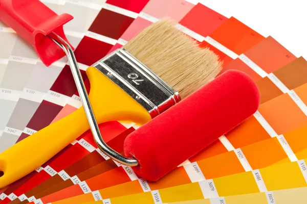 Paintbrush, paint roller and color samples