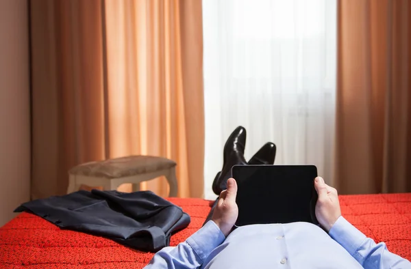 Relaxed businessman holding a pad