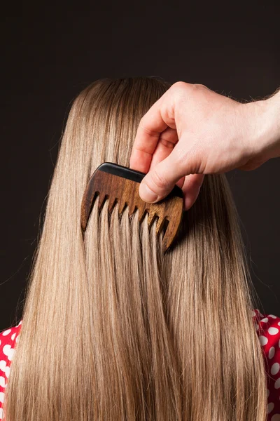 Hand combing beautiful long hair