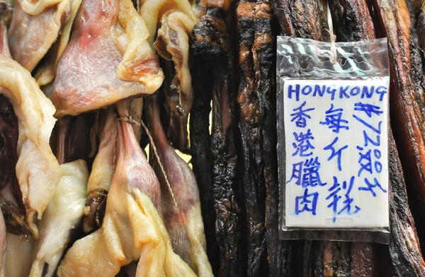 Preserved meat hanging at a Hong Kong market stall