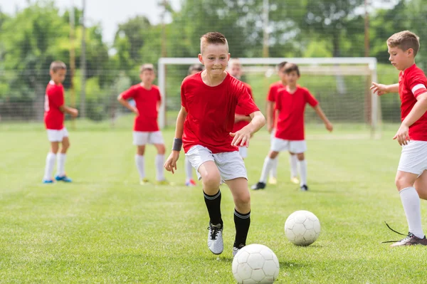 Boys kicking ball