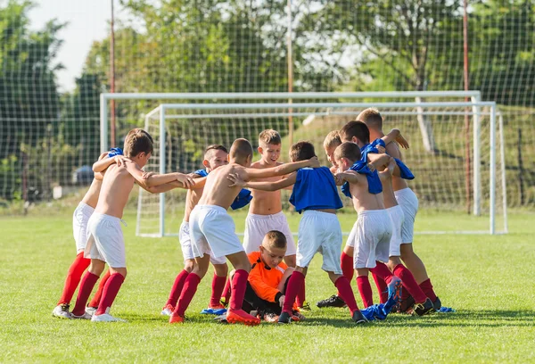 Kids soccer team in huddle