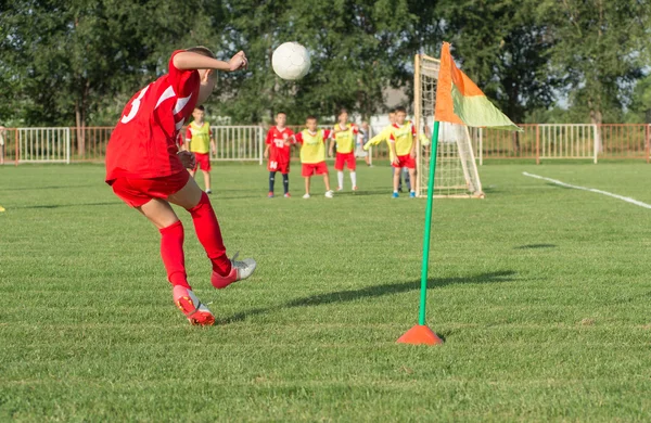 Boys kicking football