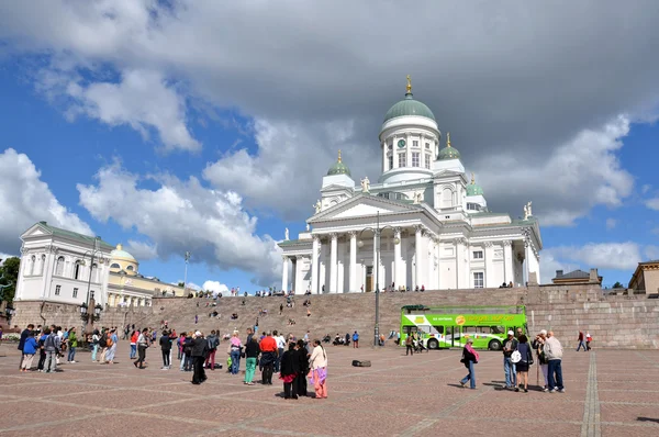 HELSINKI / FINLAND - July 20, 2013: White Helsinki Cathedral, the evangelical lutheran church. At the picture are many people and green tourist bus.