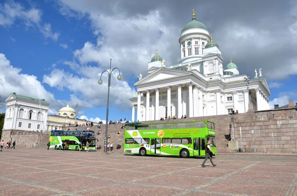 HELSINKI / FINLAND - July 20, 2013: White Helsinki Cathedral, the evangelical lutheran church. At the picture are many people and green tourist bus.