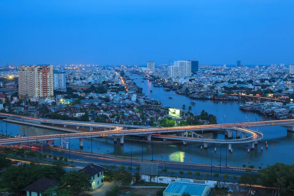 Saigon twinlight , Aerial view of Ho Chi Minh city at blue hour view from the high, Traffic around Nguyen Van Cu Bridge