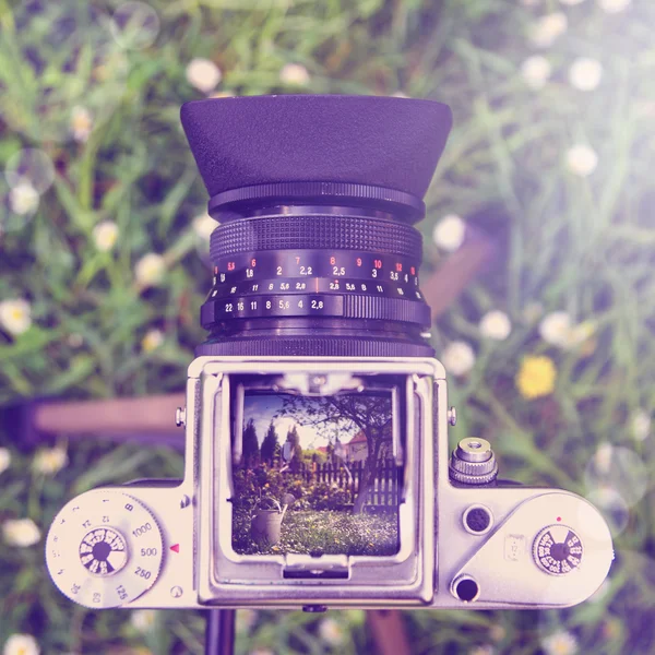 Outdoor gardening tools and flowers through the old camera  with instagram effect retro vintage filter