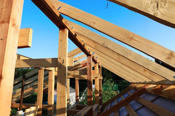Installation of wooden beams at construction of the frame house