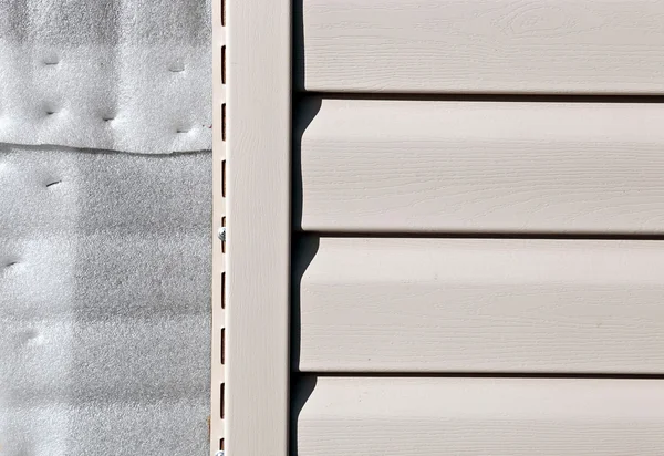 Installation on facade panels beige vinyl siding