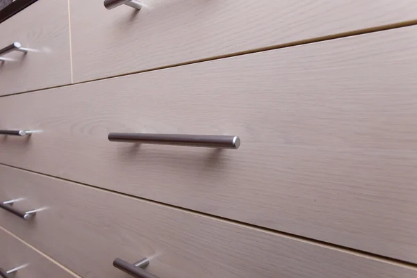 Wooden wardrobe drawer front, metal handle