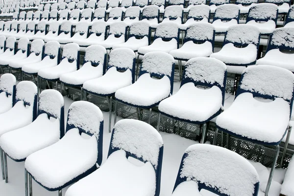 Stadium chairs covered in snow