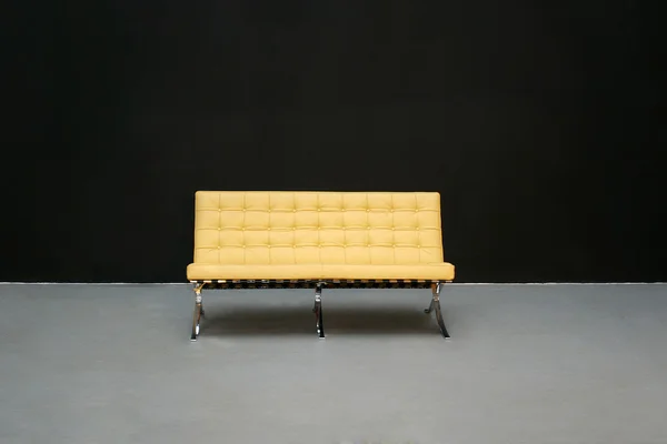 Yellow sofa isolated on black background