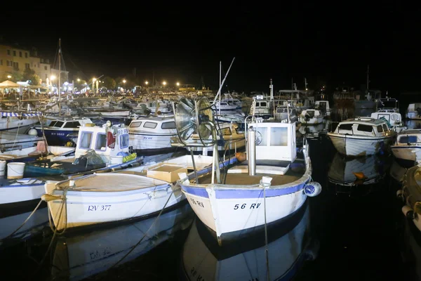 Boats in marina at night