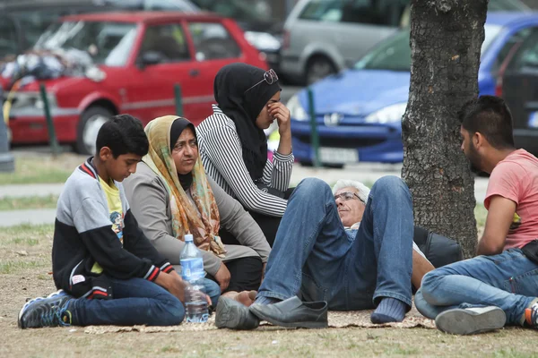 Refugees resting on ground in Belgrade
