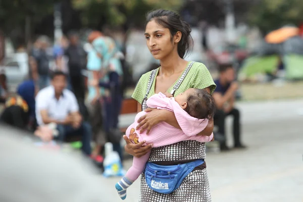 Syrian refugee woman with child in Belgrade