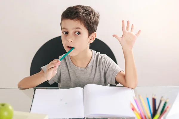 Candid portrait of a boy doing his homework and studying at home