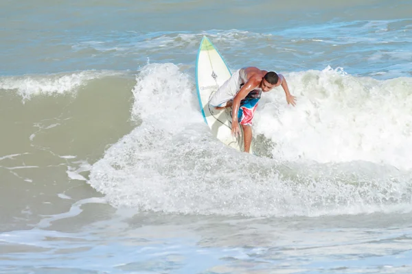Cabedelo, Paraiba, Brazil - September 18, 2016 - Young man surfs in Intermares Beach