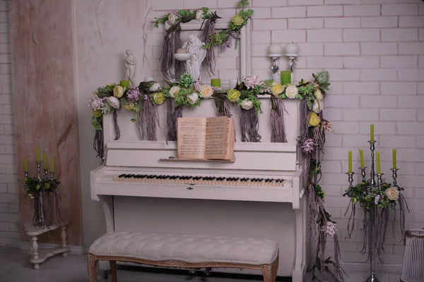 White piano and beautiful chrysanthemum flowers