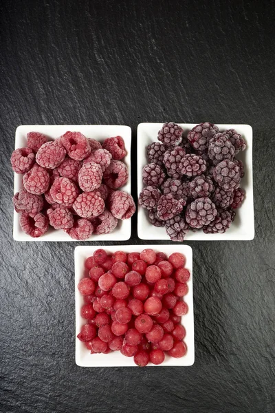 Bowls with three kinds of frozen berries