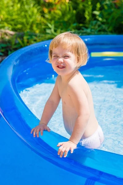 Funny little girl is in swimming pool