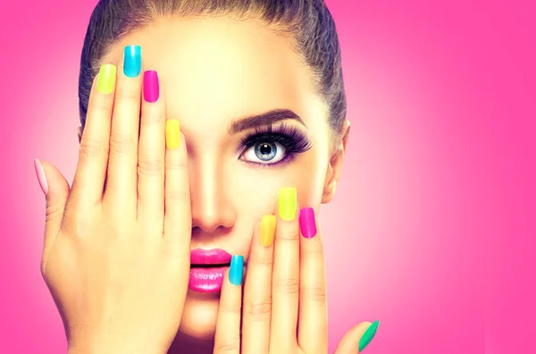 Girl face with colorful nail polish