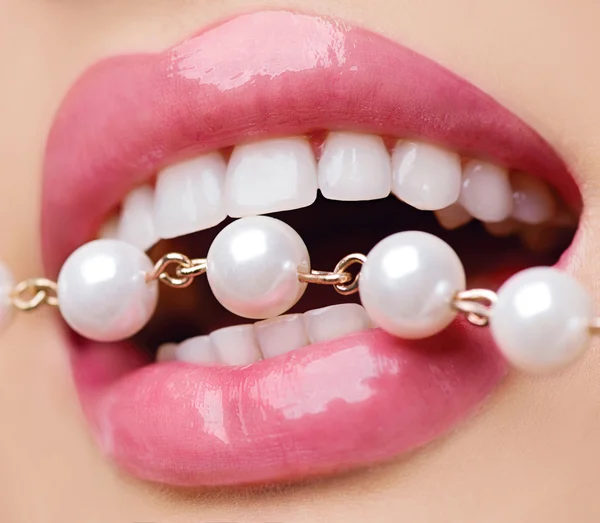 Woman smiles showing white teeth