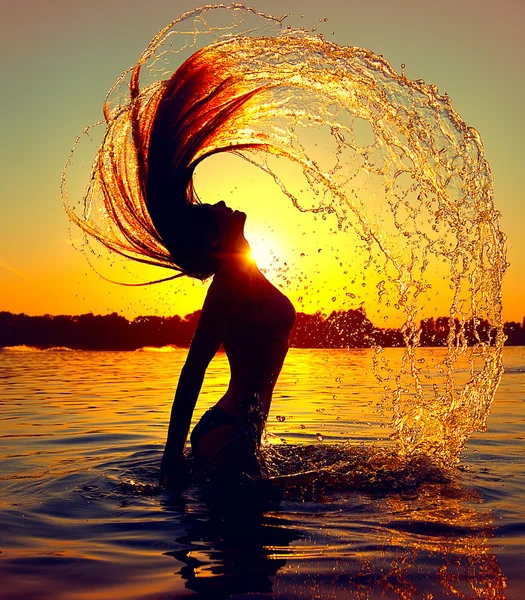 Girl splashing water with her hair