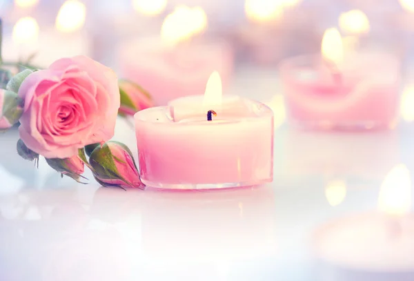 Pink  candles and rose flowers