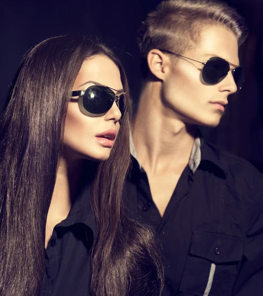 Fashion models couple wearing sunglasses