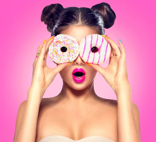 Girl taking colorful donuts.