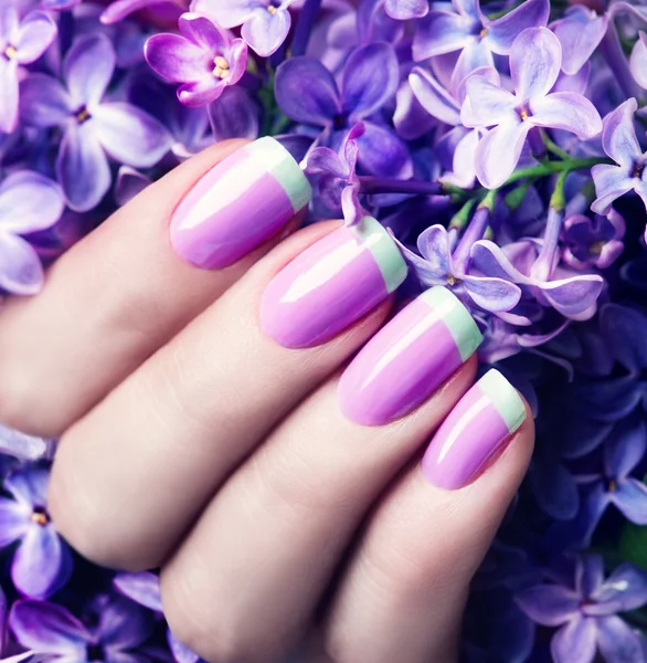 Violet with green manicure with lilac flowers