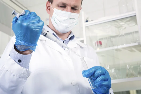 Male researcher at his workplace in the laboratory.