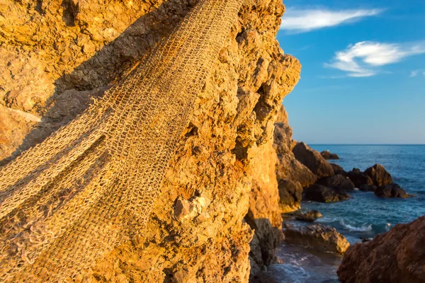 Fishing net hanging on the stone. Black sea.