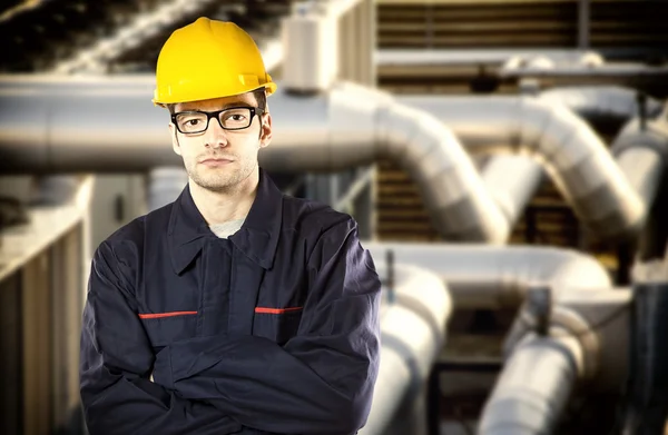 Worker in protective uniform and protective helmet