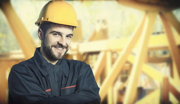 Smiling worker in protective uniform and protective helmet