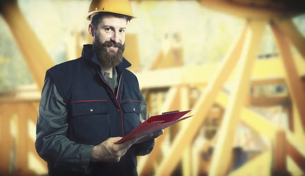 Smiling worker in protective uniform and protective helmet