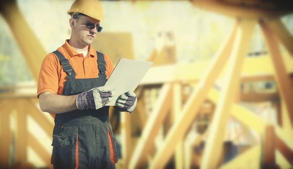 Worker in protective uniform and protective helmet