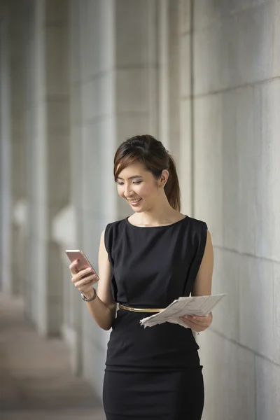 Chinese businesswoman using her smartphone