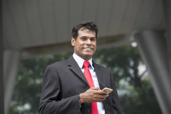 Indian businessman using his smartphone