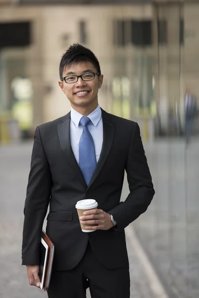 Asian businessman outside office building.