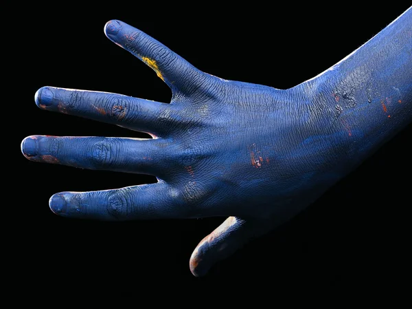 Blue hand on a black background, isolated, paint
