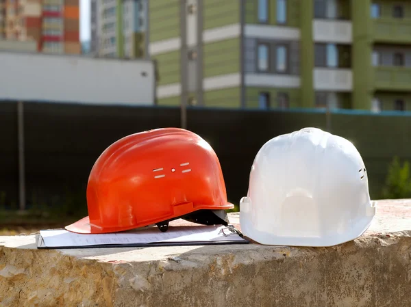 Orange helmet builder and a white  engineer