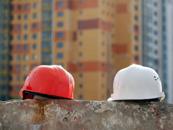 Orange helmet builder and a white  engineer