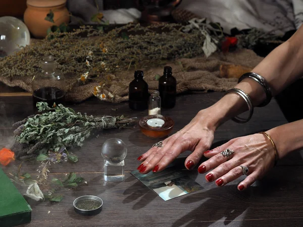Work hereditary Sage. Find people on photos. Hands witch. working table magician. Photo missing person. The magic transparent sphere. Many medicinal herbs. Magic, psychic, occult, magic